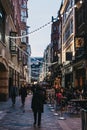 People walking under the strings of lights in Kingly Street, London, UK