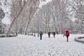 People walking under a winter heavy snow