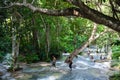 People walking up the rocks in waterfall of Konoko Gardens, Ochos Rios, Jamaica Royalty Free Stock Photo