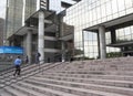 People walking up stairs of modern building