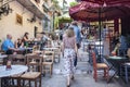 People Walking Up the Steps Through an Outdoor Dining Area in the Plaka District