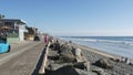 People walking, waterfront promenade beachfront boardwalk. Ocean beach near Los Angeles, California USA