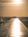 people walking on the wavebreaker in the sea - vintage effect Royalty Free Stock Photo