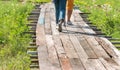 People walking on the wooden bridge in flowers field