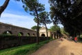 People walks along Aurelian wall around Ancient Rome on Aurelia Antica street