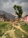 People walks on trodden paths on the grass in the village Manthali in Ramechhap District in Nepal