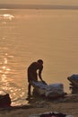 People washing clothes at Ganges river bank in Varanasi, India