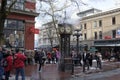 People watch gastown`s famous steam-powered clock strike 3:00 pm