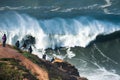 People watching big waves in Nazare, Portugal