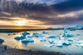 People watching icebergs in a beautiful glacial lagoon at sunset Royalty Free Stock Photo