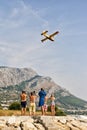 People watching and making photos of firefighters airplane in action