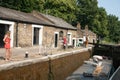 People watching the passing of a long boat through London lock. Royalty Free Stock Photo