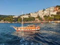 People watching the scenery in a tourist boat sailing in the bosphorus in a sunny day in Istanbul. Buildings and people on the Royalty Free Stock Photo