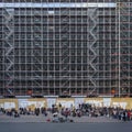 People watching the street musician in front of scaffolding. Palais Garnier renovation in Paris, France Royalty Free Stock Photo