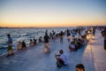 People watching sunset over the Adriatic sea in Zadar city Croatia Republic