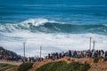 People Watching Surfer Riding Giant Wave in Nazare, Portugal