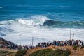 People Watching Surfer Riding Giant Wave in Nazare, Portugal Royalty Free Stock Photo