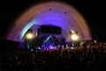 People wave hands in the air as Band plays on stage at MayJah RayJah