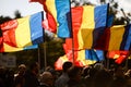People wave the Romanian flag during a rally