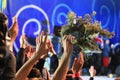 People waving hands and wreaths at a concert Royalty Free Stock Photo