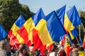 People waving many Romanian flags at anti-restrictions rally.