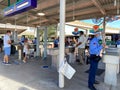 People wearing face masks and social distancing while going through security at Walt Disney World Resorts in Orlando, FL