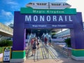 People wearing face masks and social distancing while waiting in line to get on the monorail at Walt Disney World Resorts in