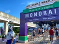 People wearing face masks and social distancing while waiting in line to get on the monorail at Walt Disney World Resorts in