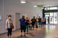 People wearing face protective mask while waiting in line at the social security office at France to prevent coronavirus