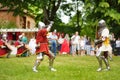 People wearing knight costumes fight during historical reenactment on annual Medieval Festival, held in Trakai Peninsular Castle