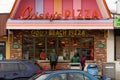 People wearing masks at a pizza shop on boardwalk