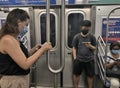 People Wearing Protective Face Mask Riding the MTA Subway Public Transit Royalty Free Stock Photo