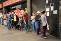 People wearing protective masks standing on lines waiting to enter supermarket during quarantine crisis caused by Covid-19