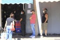 People wearing protective masks standing on lines waiting to enter supermarket during quarantine crisis caused by Covid-19