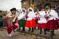 People wearing traditional clothes and masks dancing the Huaylia in the Christmas day in front of the Cuzco Cathedral in Cuzco, Pe