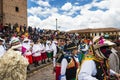 People wearing traditional clothes and masks dancing the Huaylia in the Christmas day in front of the Cuzco Cathedral in Cuzco, Pe