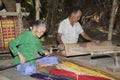 People weaving sedge grass mats.