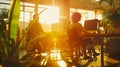 People in wheelchairs working in an office with bright sunlight filtering in. Promoting workplace accessibility and Royalty Free Stock Photo