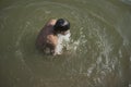 A man is bathing in Ganga River in Varanasi