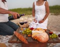 People at wine outdoor party. Man pouring red wine in to the win Royalty Free Stock Photo