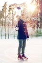 Happy young man with smartphone on ice rink Royalty Free Stock Photo