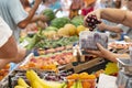 People woman man buying fresh organic cherry at street market. Selling fruits and vegetables in plastic bag, pay money Royalty Free Stock Photo