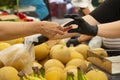 People woman man buying fresh organic fruits and vegetables at street market. Selling fruits in plastic bag, pay money Royalty Free Stock Photo