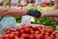 People woman man buying fresh organic fruits and vegetables at street market. Selling fruits in plastic bag, pay money Royalty Free Stock Photo