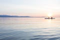 People women sea kayaking paddling boat in calm water together at sunset. Active outdoor adventure water sports. Journey,