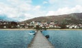 People in wood pier over Plav lake. Fisherman small coast town with ferryboats in Montenegro