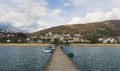 People in wood pier over Plav lake. Fisherman small coast town with ferryboats in Montenegro