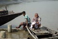 People in wooden boat crosses the Ganges River in Gosaba, West Bengal, India