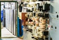 People work in a relay room at a power plant