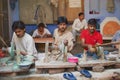 People work in a workshop creating traditional floral marble design, produced by muslim Bharai community in Agra, India.